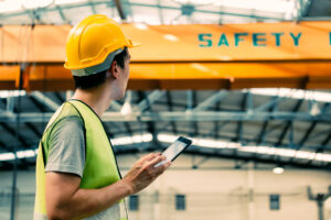 construction worker filling out near miss reports on phone
