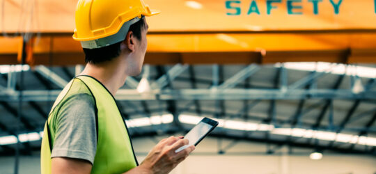 construction worker filling out near miss reports on phone
