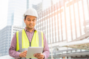 engineer on construction site using tablet for mobile apps