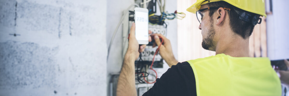 man performing electrical inspection using checklist
