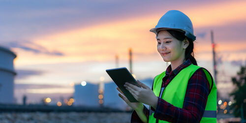 woman on job site using a tablet to perform a quality control inspection