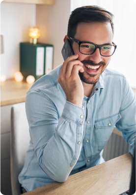 Smiling man talking on a mobile phone.