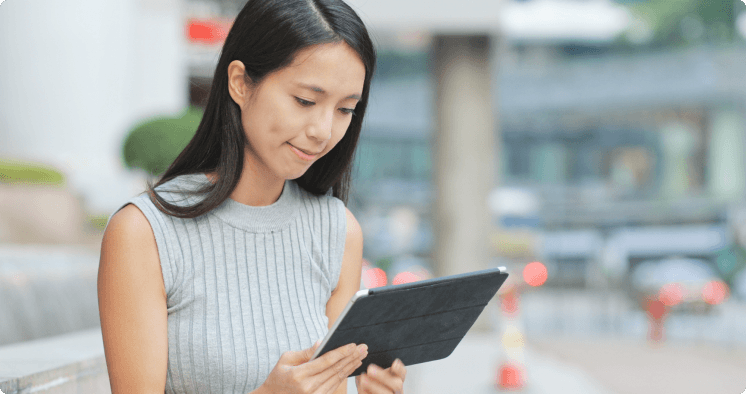 Woman reviewing information on a tablet.