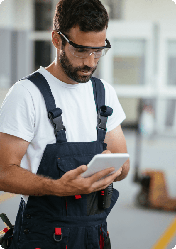 Man in field service industry looking at tablet using digital forms.