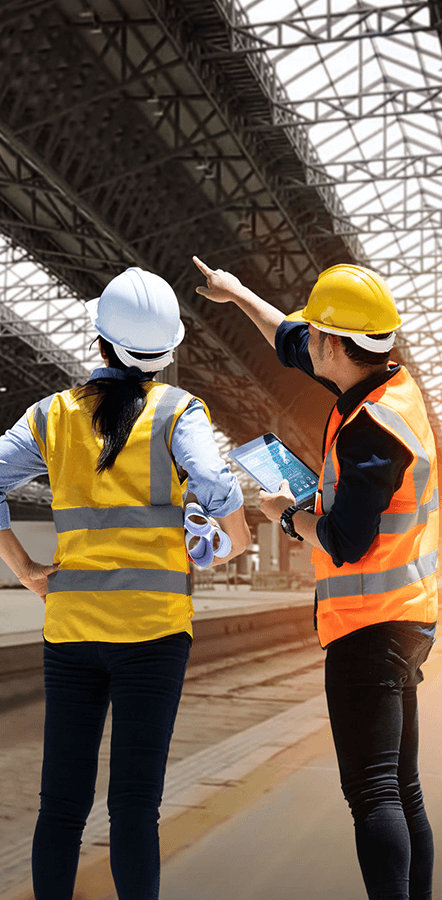 Two people collecting data on ipad at a job site using GoCanvas digital forms.