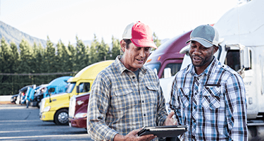 Image of Two Men and a Truck looking at tablet.