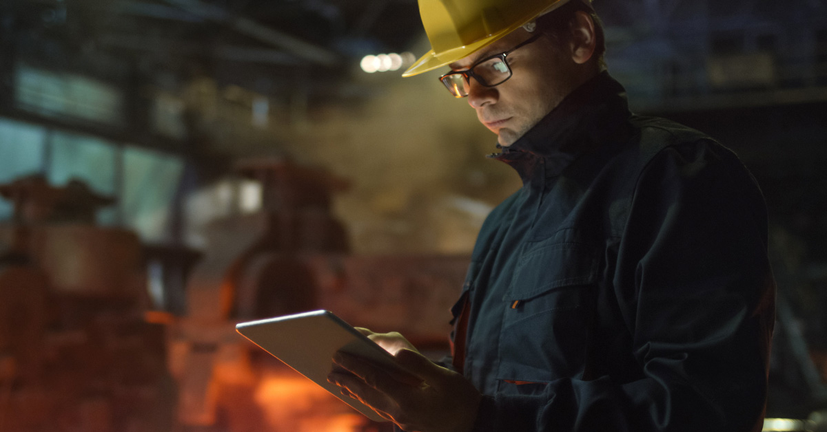 Man in oil and gas industry using digital forms on tablet.