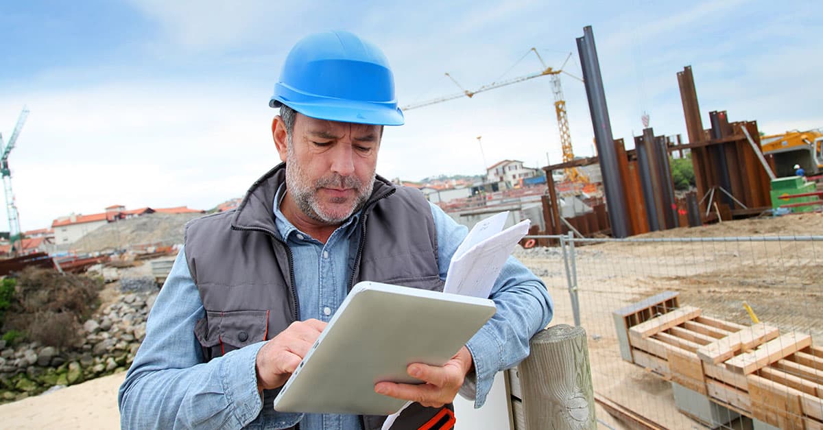 man using tablet at construction site